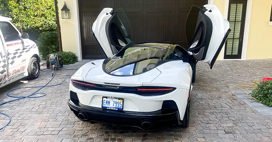 Butterfly doors open on this freshly detailed sports car.